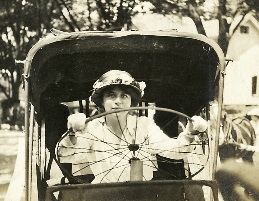 Polly Porter-Dewson at the wheel, Castine Historical Society