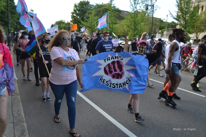 Protesters marching with TRANS RESTISTANCE banner, June 13, 2020 Trans Resistance March, Franklin Park, Boston. Photograph by Jo Trigilio.